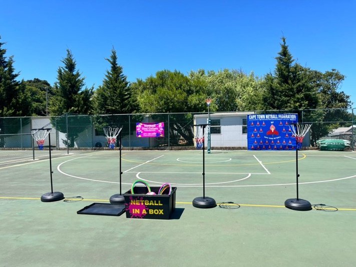 A Netball in a Box set up on an outdoor court, with poles and cones laid out
